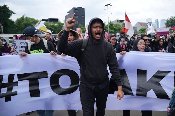 A protester shouts slogans during a rally against the passing of a new military law allowing active military personnel to hold more civilian posts, outside the parliament in Jakarta, Indonesia, Thursday, March 20, 2025. (AP Photo/Tatan Syuflana)