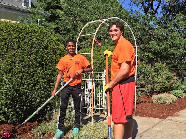 Volunteers Robert Morris (left) and Steven van Tiflin tend the Edward Cooper Community Garden in Roxbury, Mass., during a service tour there last year. CONTRIBUTED