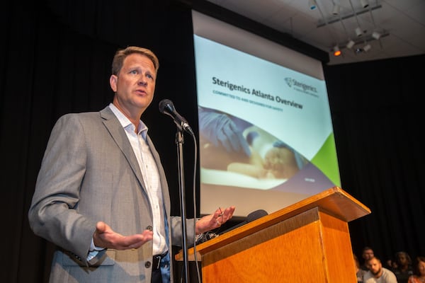 Sterigenics President Philip Macnabb talks to a packed house at Campbell Middle School during a July community meeting to address concerns over ethylene oxide emissions. STEVE SCHAEFER / SPECIAL TO THE AJC