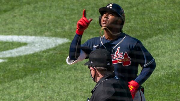 Atlanta Braves' Ozzie Albies gestures as he rounds bases after hitting a two-run home run during the sixth inning of a baseball game against the Washington Nationals in Washington, Sunday, Sept. 13, 2020. (AP Photo/Manuel Balce Ceneta)