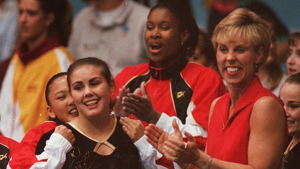 Georgia's Jenni Beathard (left) is congradulated by her coach Suzanne Yoculan and teammates after her first place performance in the uneven bars Saturday April 19, 1997.