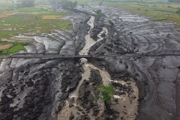 FILE - People examine the damage at an area badly affected by a flash flood in Tanah Datar, West Sumatra, Indonesia, May 13, 2024. (AP Photo/Ali Nayaka, File)