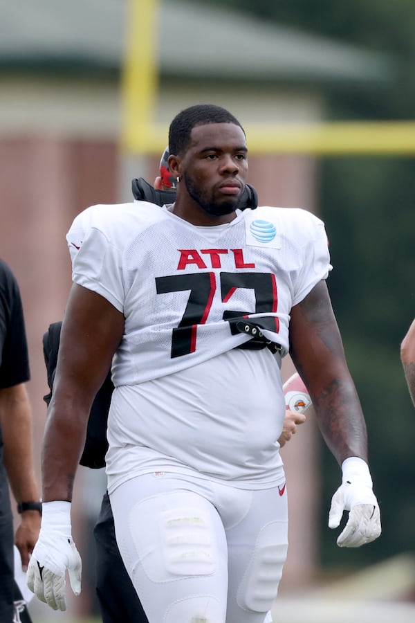 Falcons offensive lineman Leroy Watson takes a break during training camp Monday in Flowery Branch. (Jason Getz / Jason.Getz@ajc.com)