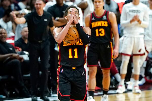 Atlanta Hawks guard Trae Young (11) reacts after bring fouled by Miami Heat forward P.J. Tucker during the second half of Game 2 of an NBA basketball first-round playoff series, Tuesday, April 19, 2022, in Miami. The Heat won 115-105. (AP Photo/Lynne Sladky)