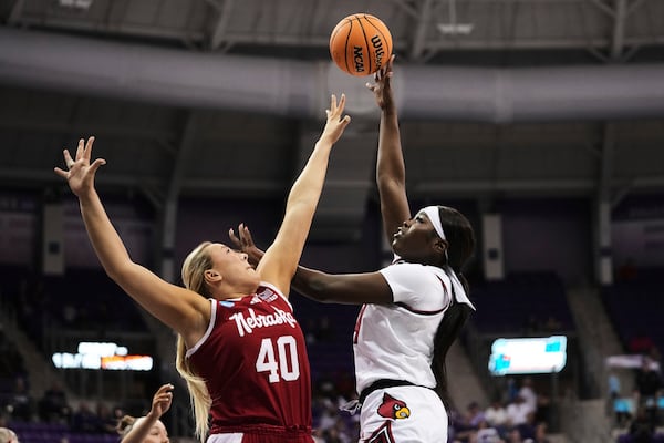 Louisville forward Mackenly Randolph, right, shoots over Nebraska's Alexis Markowski (40) in the first half in the first round of the NCAA college basketball tournament in Fort Worth, Texas, Friday, March 21, 2025. (AP Photo/Tony Gutierrez)