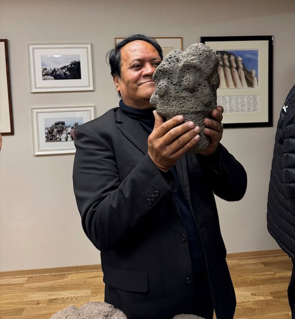 In this photo provided by the Kon-Tiki Museum press service on Wednesday, Nov. 13, 2024, a person holds an artifact taken from Easter Island, also known as Rapa Nui, by a Norwegian explorer in the late 1940s, during the "repatriation" ceremony at the Kon Tiki Museum in Oslo, Norway, Tuesday, Nov. 12, 2024. (Kon-Tiki Museum press service via AP)