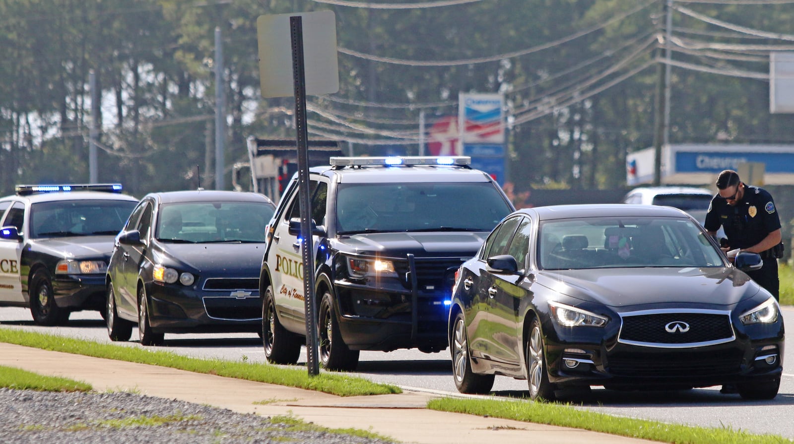 July 16, 2019 Kennesaw- A police officer issues a citation during an undercover traffic operation on Cobb Parkway in Kennesaw, Georgia on Tuesday, July 16, 2019. The Cobb County, Acworth and Kennesaw police departments along with the Georgia State Patrol conducted a Hands-Free Traffic Operation starting at 9 a.m Tuesday morning. The operation was similar to that conducted previously by the Marietta Police Department and involved an undercover element. Officers posed as Cobb County Transit workers to spot drivers not complying with Georgia's hands free driving law. The undercover officers alerted other uniformed officers of violating drivers, who then issued tickets. Christina Matacotta/Christina.Matacotta@ajc.com