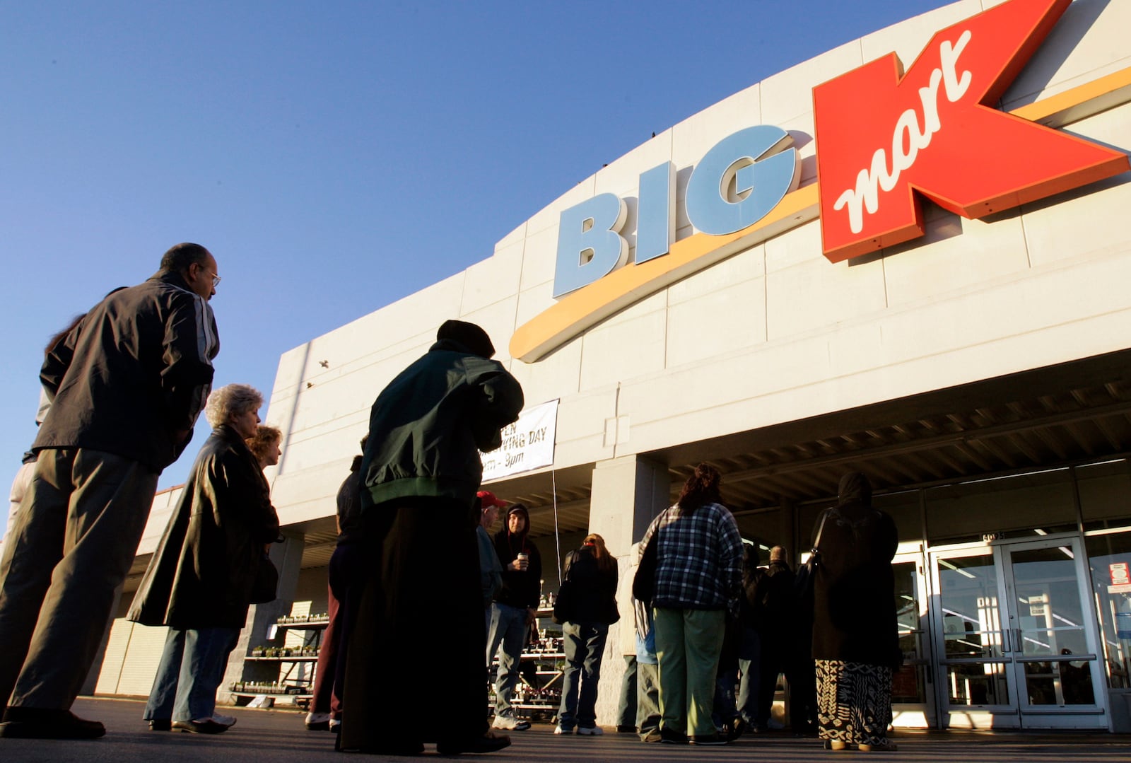 FILE - Shoppers wait outside a Kmart store for a 7 a.m. Thanksgiving Day sale in Nashville, Tenn., on Nov. 23, 2006. (AP Photo/Mark Humphrey, File)