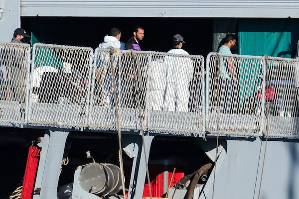 Migrants disembark from the Italian navy ship Libra at the port of Shengjin, northwestern Albania, Friday, Nov. 8, 2024, as a second group of eight migrants intercepted in international waters is processed in a reception facility despite the failure with the first group in October. (AP Photo/Vlasov Sulaj)