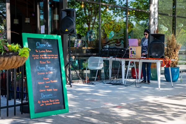 A DJ pumped out loud Latin hits from the sidewalk outside Tio Lucho's in Atlanta's Poncey-Highland neighborhood.