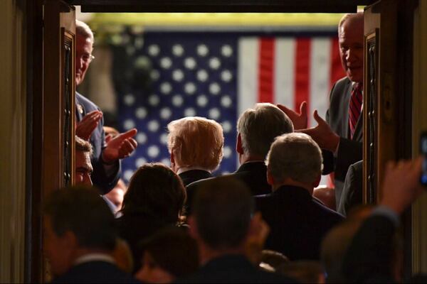 In this Jan. 30, 2018, file photo President Donald Trump walks into the House Chamber as he arrives for his State of the Union address to a joint session of Congress on Capitol Hill in Washington. The State of the Union address puts the president, his Cabinet, members of Congress, military leaders, top diplomats and Supreme Court justices all in the same place at the same time for all the world to see. Protecting everyone requires months of planning and coordination involving multiple law enforcement agencies, led by the U.S. Secret Service. 