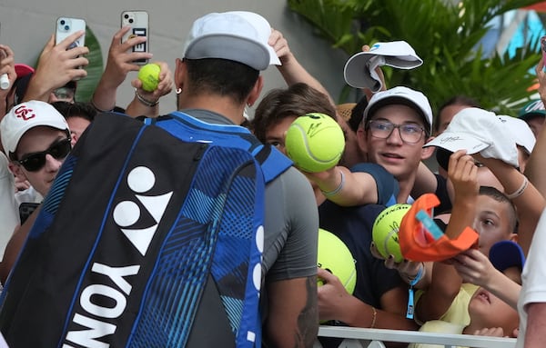 Nick Kyrgios, of Australia, signs autographs after defeating Mackenzie McDonald during the Miami Open tennis tournament, Wednesday, March 19, 2025, in Miami Gardens, Fla. (AP Photo/Lynne Sladky)