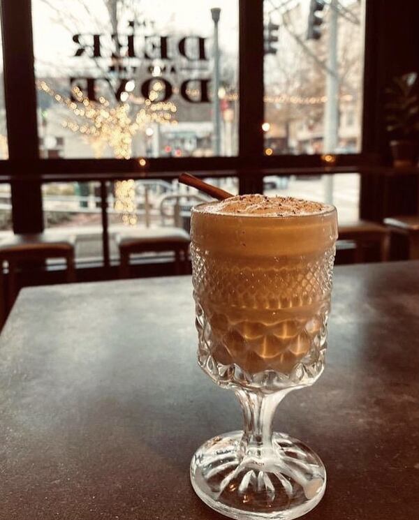 Deer and the Dove bartenders grate fresh ground nutmeg over their eggnog, served in antique family glassware. Courtesy of Terry Koval