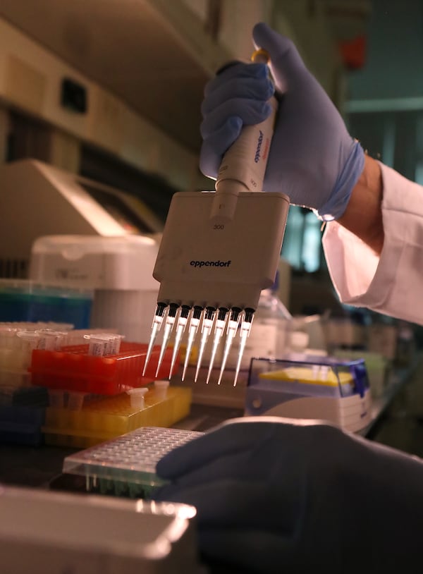 Project manager John Nechtman performs RNA template preparation in the genomics core laboratory at Augusta University Medical Center. (Curtis Compton / Curtis.Compton@ajc.com)