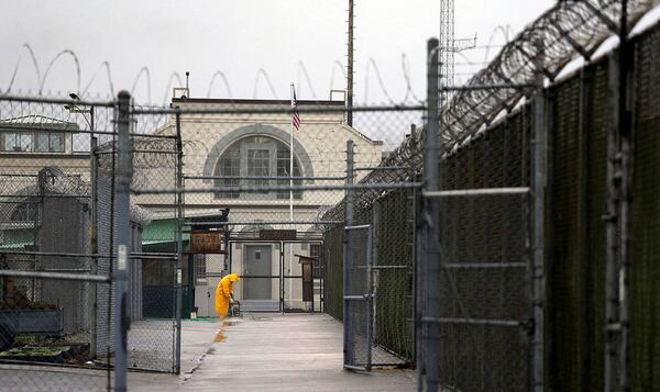 In this 2016 photo, a man does maintenance work between razor wire-topped fences at the Monroe Correctional Complex in Monroe, where more than 100 inmates were involved in a “disturbance.”