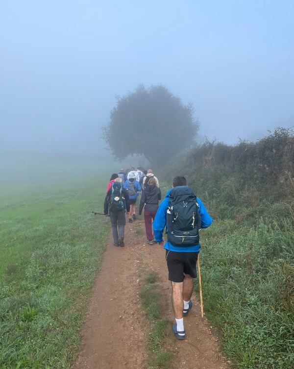 A foggy morning and a crowded stretch on El Camino de Santiago