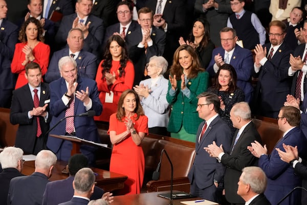 Rep. Lisa McClain, R-Mich., center left, and others applaud House Speaker Mike Johnson, R-La., as the House of Representatives meets to elect a speaker and convene the new 119th Congress at the Capitol in Washington, Friday, Jan. 3, 2025. (AP Photo/Mark Schiefelbein)