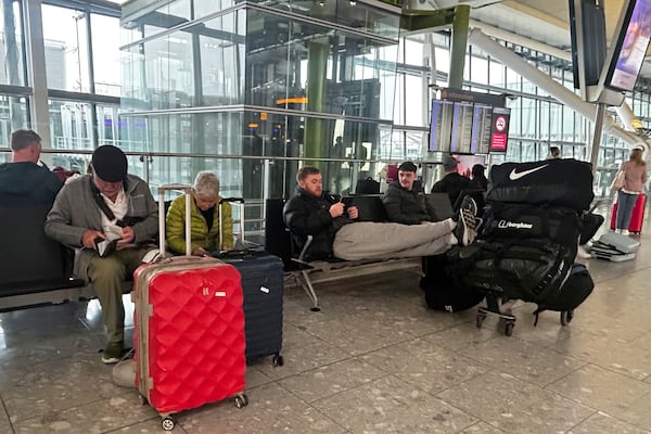 Travellers wait at Terminal 5 as Heathrow Airport slowly resumes flights after a fire cut power to Europe's busiest airport in London, Saturday, March 22, 2025.(AP Photo/Kirsty Wigglesworth)