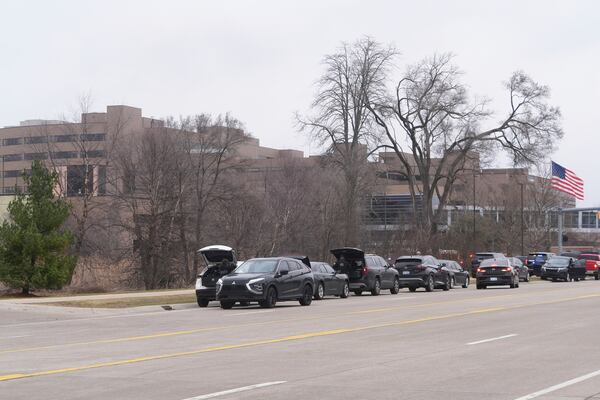 Law enforcement arrive at Corewell Health Beaumont Troy Hospital in Troy, Mich., Thursday, March 20, 2025. (AP Photo/Paul Sancya)