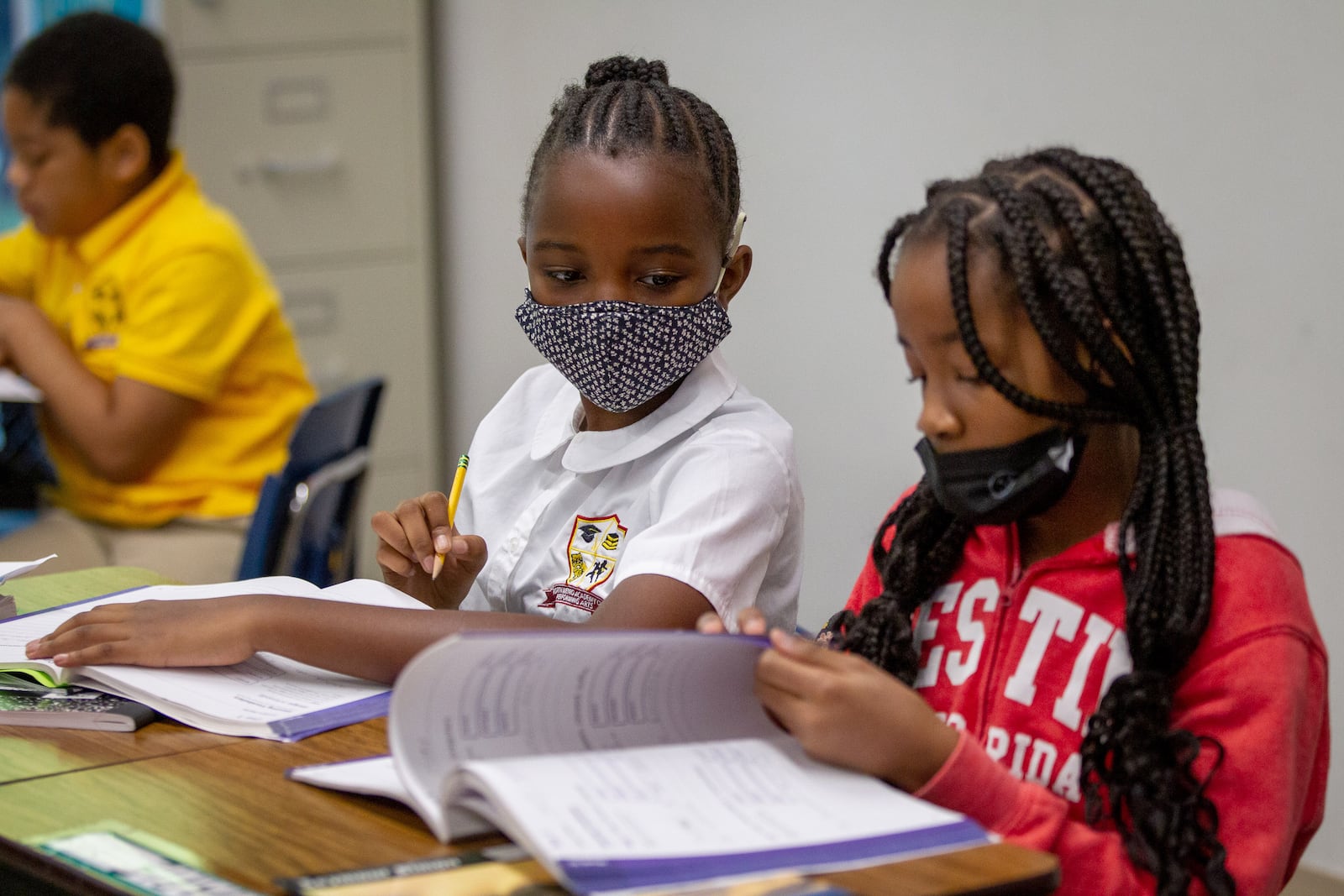 Fifth-grader Naomi Kalu, 10, works on her schoolwork at North Metro Academy of Performing Arts in Norcross on Oct. 13, 2021. STEVE SCHAEFER FOR THE ATLANTA JOURNAL-CONSTITUTION