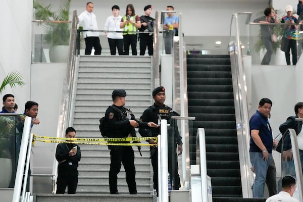 FILE - Armed police secure an area following the arrest of former Philippine President Rodrigo Duterte at the airport in Manila, Philippines on Tuesday, March 11, 2025. (AP Photo/Aaron Favila, File)