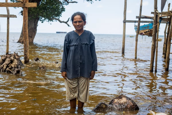 Nina, 33, a member of Bajau Tribe, poses for a photograph on Kabaena Island, in South Sulawesi, Indonesia, Friday, Nov. 15, 2024. (AP Photo/Yusuf Wahil)