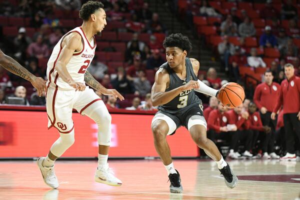 Georgia Tech guard Jaeden Mustaf (3) drives past Oklahoma guard Brycen Goodine (2) during the second half of an NCAA college basketball game, Tuesday, Dec. 3, 2024, in Norman, Okla. (AP Photo/Kyle Phillips)