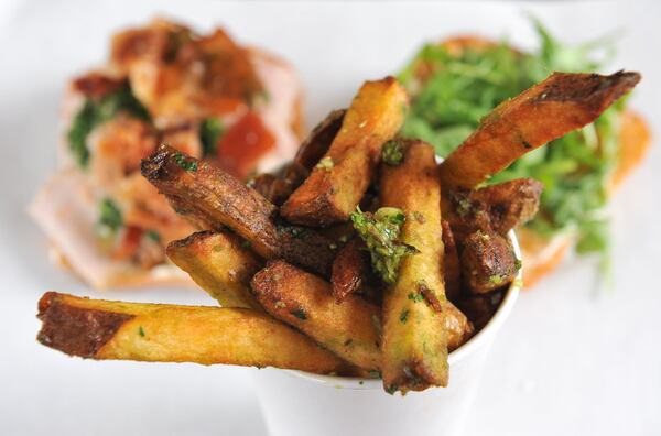 Garlic fries with porchetta in the background at Fred’s Meat & Bread, inside the Krog St Market. (Beckysteinphotography.com)