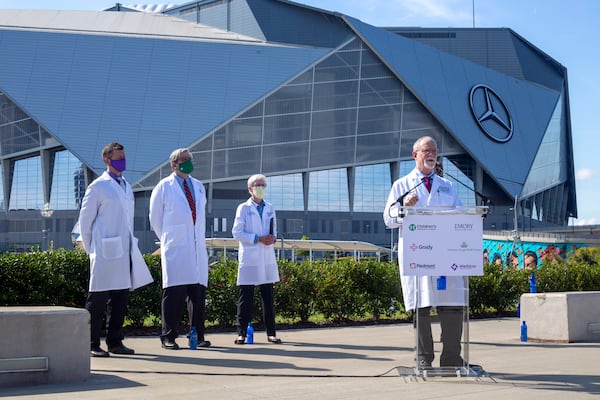 Dr. Robert Jansen, chief medical officer and chief of staff at Grady Health System, speaks at a press conference near the Mercedes-Benz Stadium in Atlanta. (Rebecca Wright for The Atlanta Journal-Constitution)