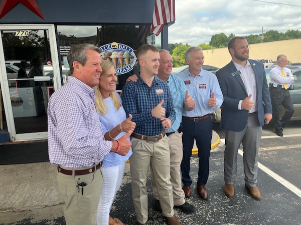 Gov. Brian Kemp and his wife Marty pose for a picture with Tyler Bell. 