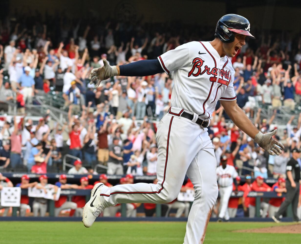 Atlanta Braves' Matt Olson hits a three-run homer during the ninth inning of game one of the baseball playoff series between the Braves and the Phillies at Truist Park in Atlanta on Tuesday, October 11, 2022. (Hyosub Shin / Hyosub.Shin@ajc.com)