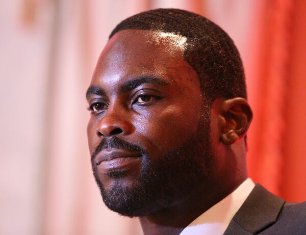  June 12, 2017, Atlanta: Michael Vick takes the podium to speak while the Atlanta Falcons honor the former Falcons quarterback and wide receiver Roddy White as they officially retire from the NFL on Monday, June 12, 2017, in Atlanta. Curtis Compton/ccompton@ajc.com