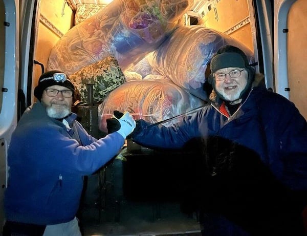 Ken Ward (left) and a volunteer deliver blankets. The power and gas grids in parts of Ukraine are wrecked, and keeping warm is often a matter of life and death. (Photo Courtesy of HelpingUkraine.US.)