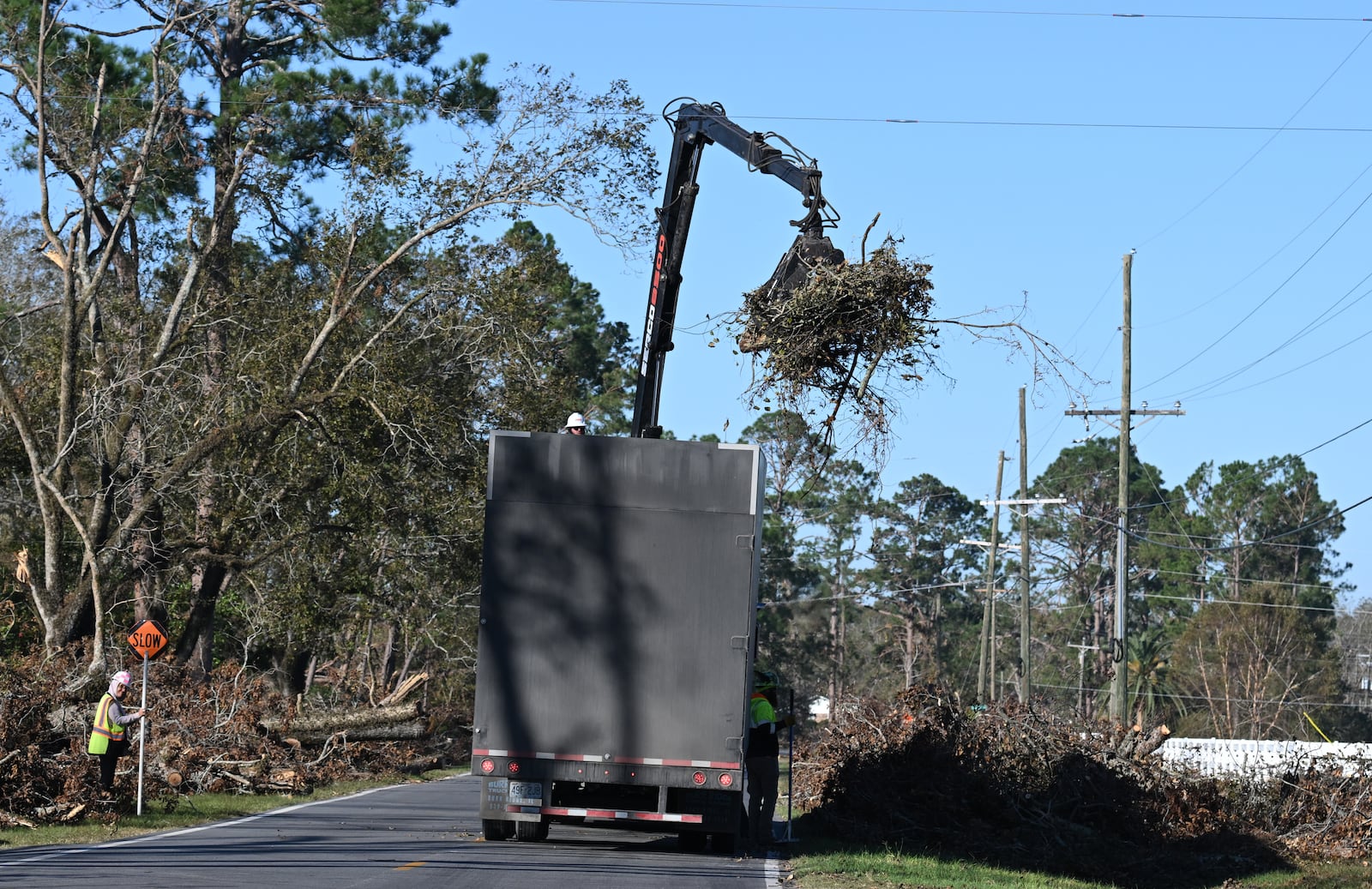 Work crews clean up debris in the aftermath of Hurricane Helene on Monday, Oct. 21, 2024, in Hazlehurst, Ga. (Hyosub Shin/AJC)