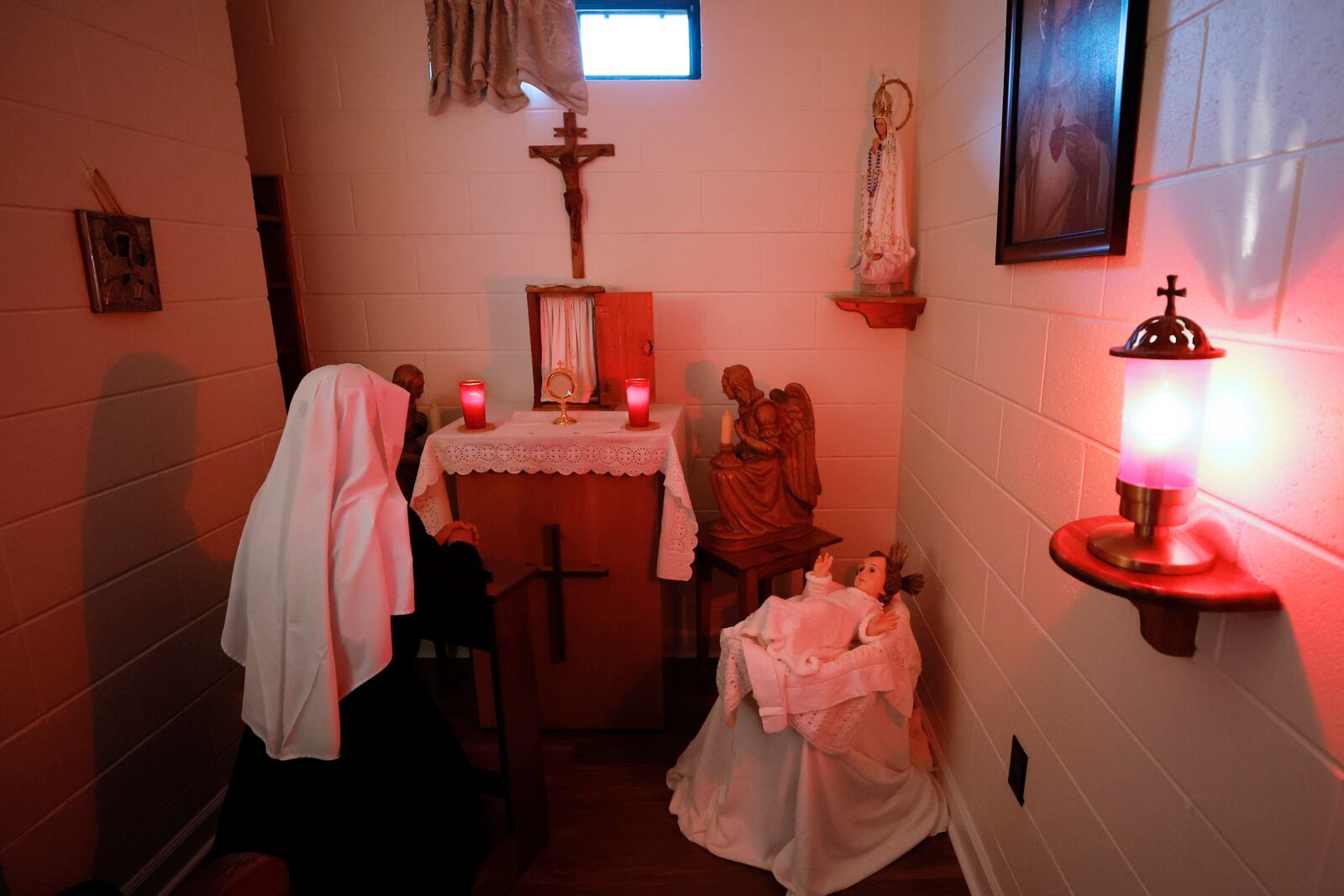 Sister Thiennga spends a moment in the prayer room as part of a daily schedule of prayers. Sisters from many countries have joined the congregation at the Monastery of the Visitation of Holy Mary in Snellville; their community has always been international and diverse.
 Miguel Martinez / miguel.martinezjimenez@ajc.com