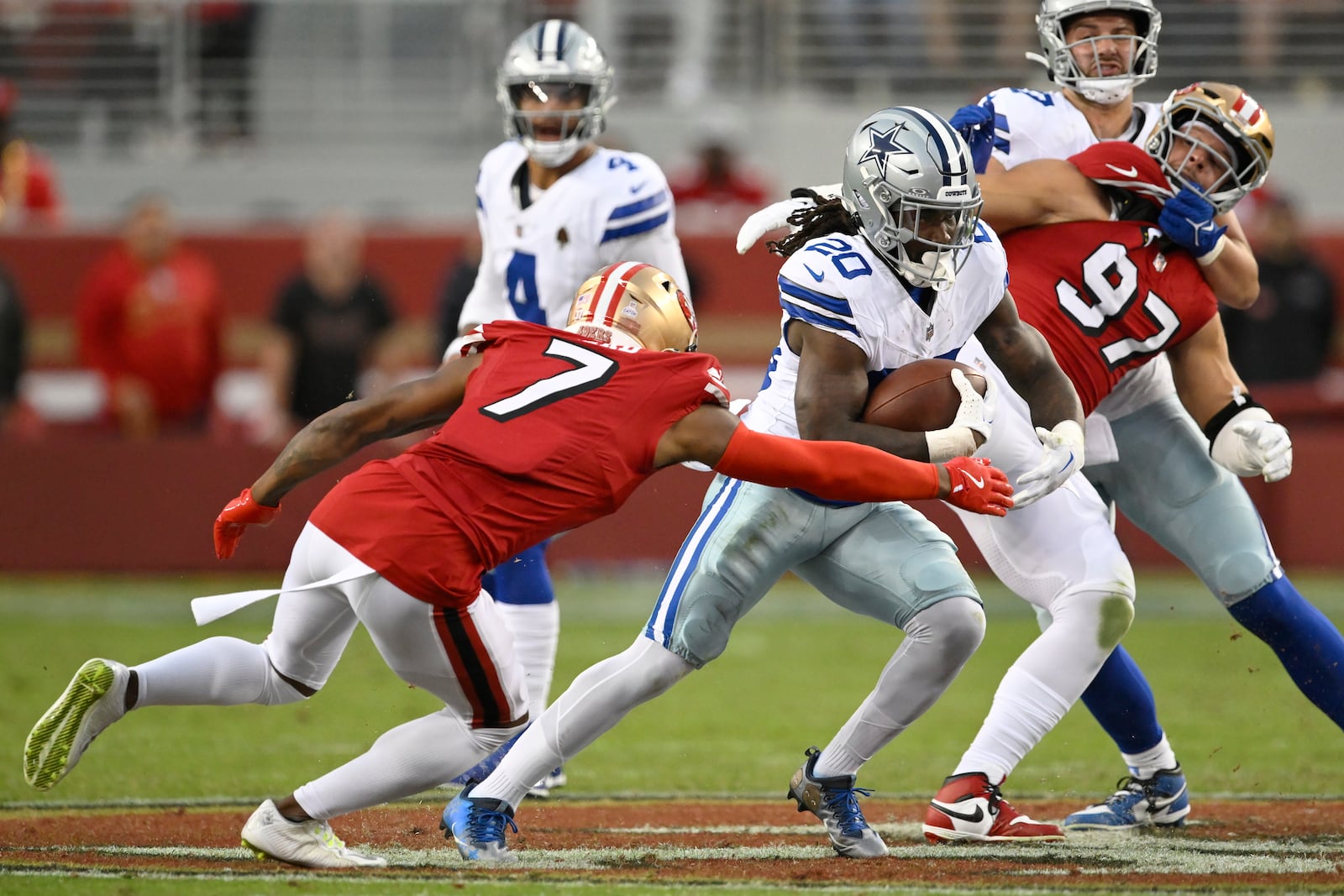 Dallas Cowboys running back Dalvin Cook (20) runs between San Francisco 49ers cornerback Charvarius Ward (7) and defensive end Nick Bosa (97) during the first half of an NFL football game in Santa Clara, Calif., Sunday, Oct. 27, 2024. (AP Photo/Eakin Howard)