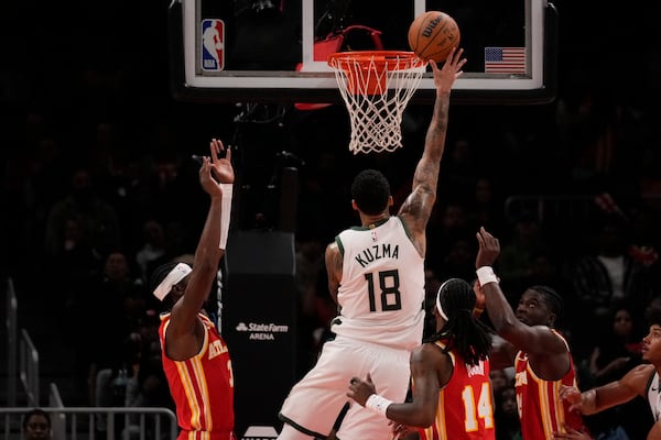 Milwaukee Bucks forward Kyle Kuzma (18) scores in the first half of an NBA basketball game against the Atlanta Hawks, Tuesday, March 4, 2025, in Atlanta. (AP Photo/Brynn Anderson)