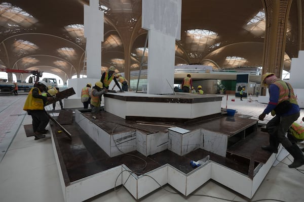 Cambodian workers work inside under a construction of a new airport of Techo International Airport at the outskirts of Phnom Penh Cambodia, Friday, March 21, 2025. (AP Photo/Heng Sinith)