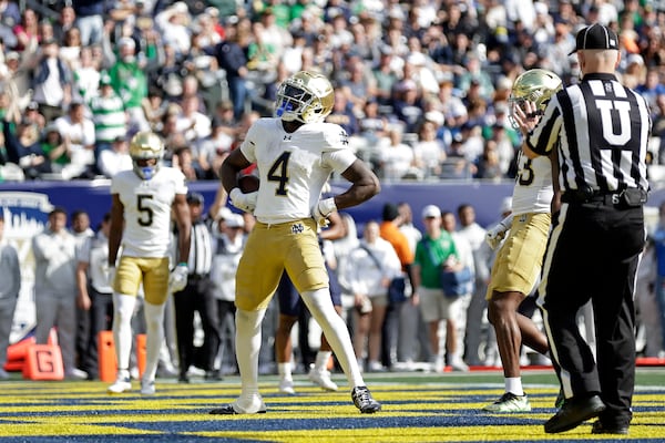 Notre Dame running back Jeremiyah Love (4) reacts after scoring a touchdown during the first half of an NCAA college football game against Navy Saturday, Oct. 26, 2024, in East Rutherford, N.J. (AP Photo/Adam Hunger)