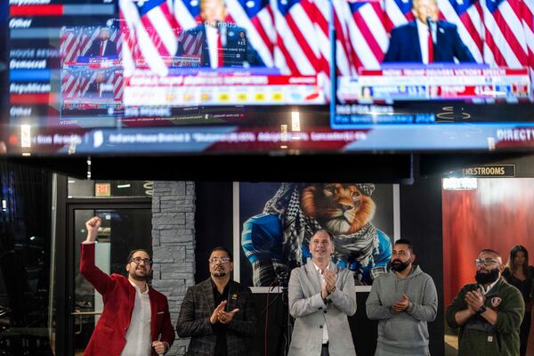 From left to right, Paul Manni, Sam Alasri, Wasel Yousaf, Waseem Makani and Abrahim Tamimi, cheer as Republican presidential nominee former President Donald Trump's speech is broadcast during an Arab Americans for Trump watch party at the Lava Java Cafe, a hookah lounge, in the early hours of Wednesday, Nov. 6, 2024, in Dearborn, Mich. (AP Photo/David Goldman)