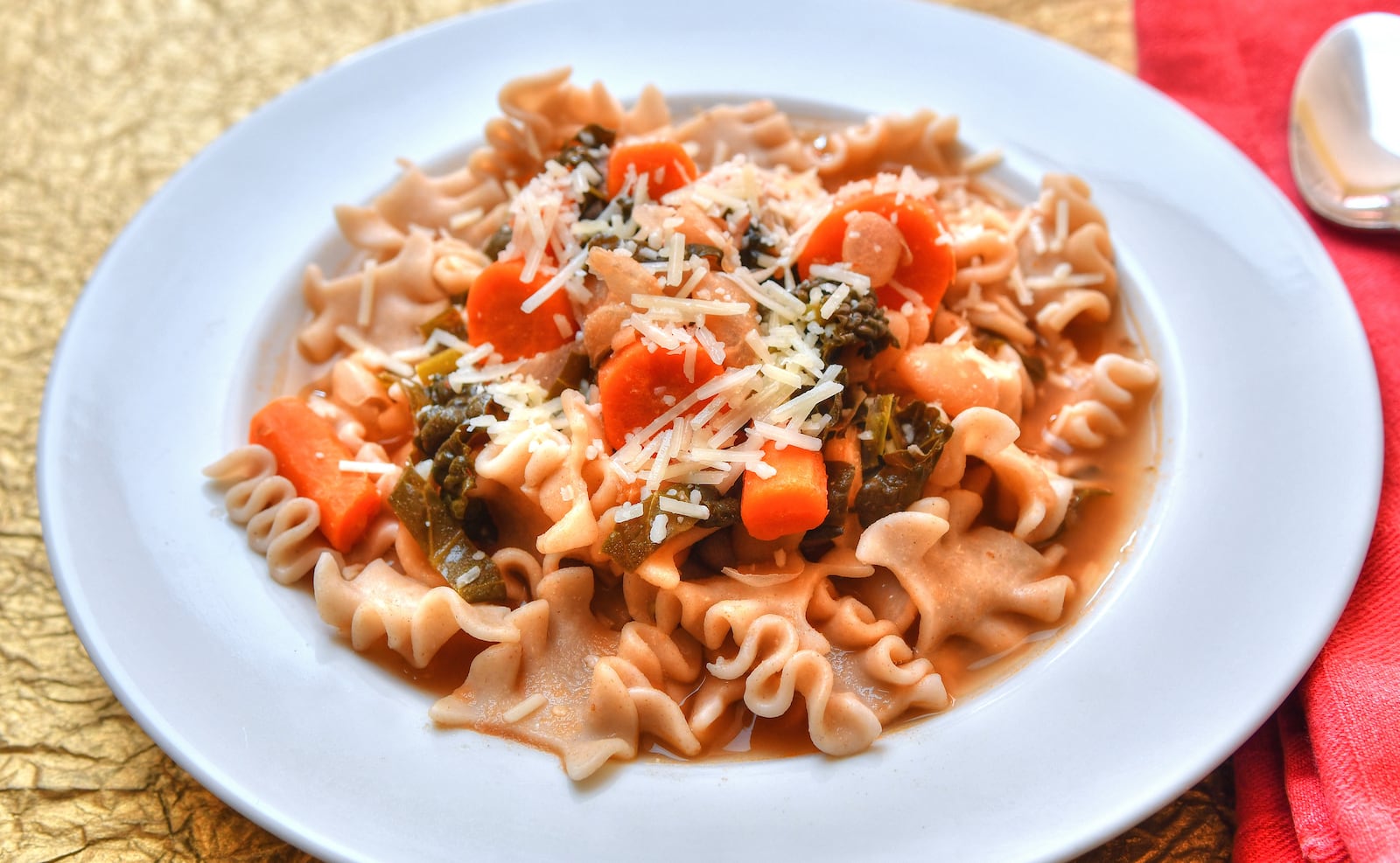 This Minestrone Soup recipe includes whole-wheat pasta and Parmesan used in two ways: a Parmesan rind in the soup, plus grated Parmesan on the top. (Styling by Jennifer Zyman / photo by Chris Hunt for the AJC)