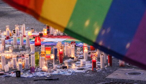 SECONDARY PHOTO - June 13, 2016 Atlanta: Candles remained burning brightly Monday morning, June 13, 2016 in the parking lot of Ten Atlanta at 990 Piedmont Ave NE, Atlanta after an overnight vigil remembering the Orlando mass shooting victims. On Sunday night at the corner of 10th Street and Piedmont Avenue in Atlanta, crowds spilled onto 10th Street and the road was closed to traffic as people remembered those injured and killed in the mass shooting at an Orlando gay club early that morning. Atlanta Mayor Kasim Reed, told residents the city had stepped up its own protections, but said he was there because it was important for him to show his support of the city's gay community The Atlanta Police Department estimated 1,000 people gathered outside of Ten, at the same corner many celebrated a Supreme Court victory last summer that made same-sex marriage legal. On Sunday, after a moment of silence, they sang "The Star-Spangled Banner," holding candles aloft. The Atlanta Freedom Bands played the hymn "Salvation is Created." JOHN SPINK /JSPINK@AJC.COM