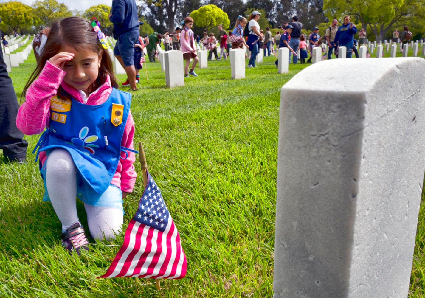 scouts place flags at veteran graves to honor memorial day