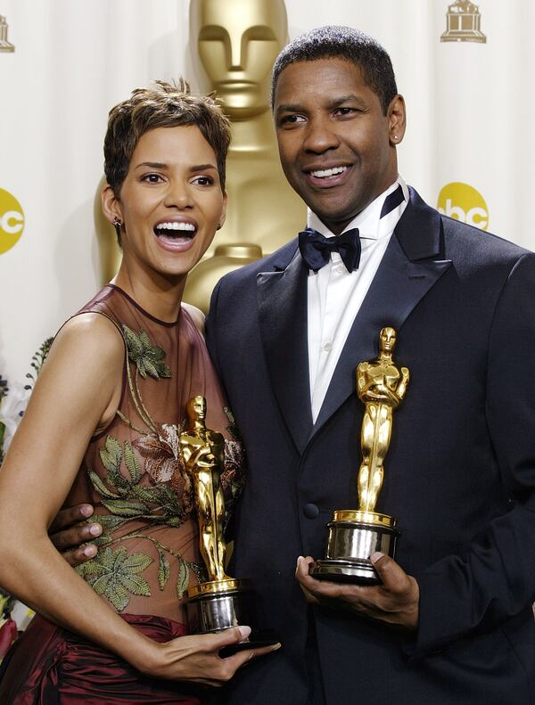 Best actress Halle Berry and best actor Denzel Washington pose for photographers with their Oscar trophies during the 74th annual Academy Awards on Sunday, March 24, 2002 in Los Angeles. (AP Photo/Doug Mills)