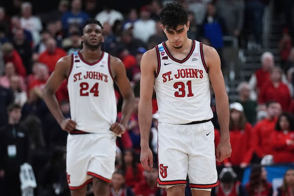 St. John's guard Lefteris Liotopoulos (31) and forward Zuby Ejiofor (24) walk down court during their loss to Arkansas during the second half in the second round of the NCAA college basketball tournament, Saturday, March 22, 2025, in Providence, R.I. (AP Photo/Charles Krupa)