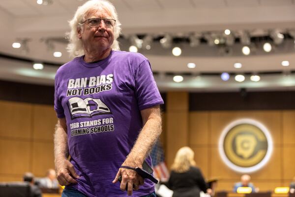 A supporter of Cobb County teacher Katie Rinderle walks out of a hearing at the Cobb County Board of Education in Marietta on Thursday, Aug. 17, 2023. Rinderle was fired after reading “My Shadow is Purple,” a book about gender identity, to fifth graders. (Arvin Temkar / arvin.temkar@ajc.com)