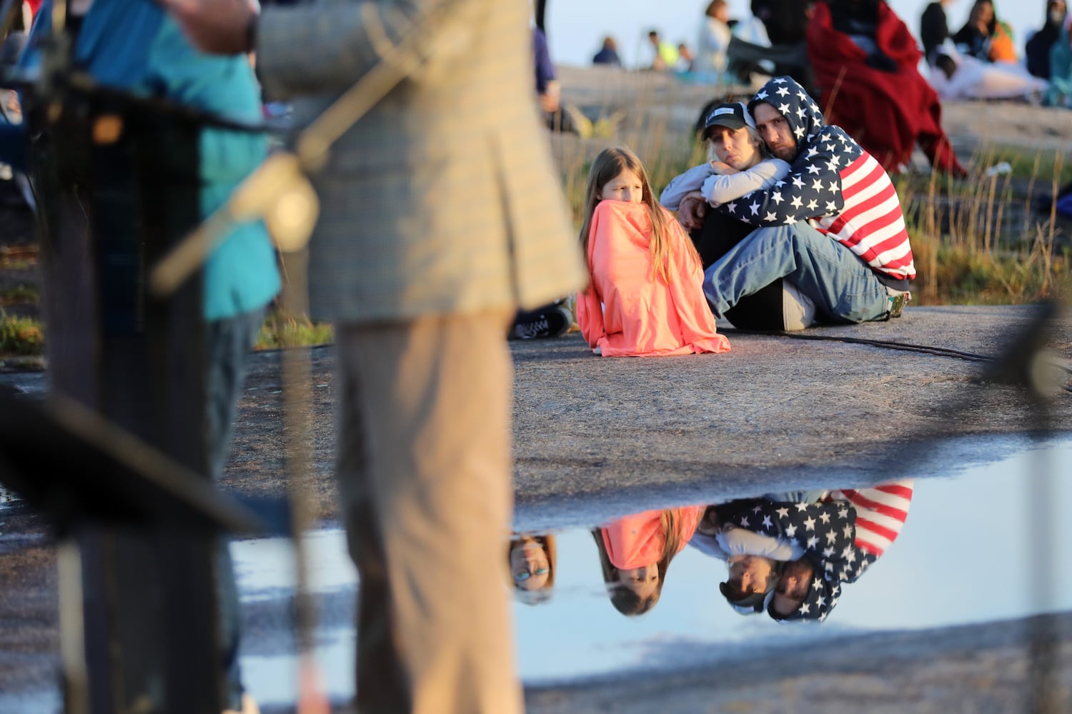 People listen to Pastor Bryant Wright deliver the message at Stone Mountain's top during the 76th annual Easter Sunrise Service on Sunday, April 17, 2022. Miguel Martinez/miguel.martinezjimenez@ajc.com