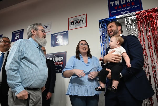 Republican vice presidential nominee JD Vance holds 10-month-old Emmalynn as her grandfather David Lowry (left) and mother Daelen Lowry (center) react as JD Vance visits Trump Force 47 - Gwinnett Field Office, Friday, October 11, 2024, in Lawrenceville. (Hyosub Shin / AJC)