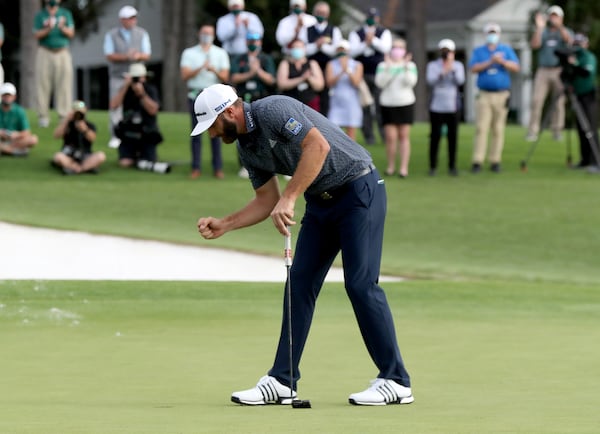 Dustin Johnson reacts after winning the 2020 Masters Tournament after sinking his putt on the 18th green Sunday, Nov. 15, 2020, at Augusta National. (Curtis Compton / Curtis.Compton@ajc.com)