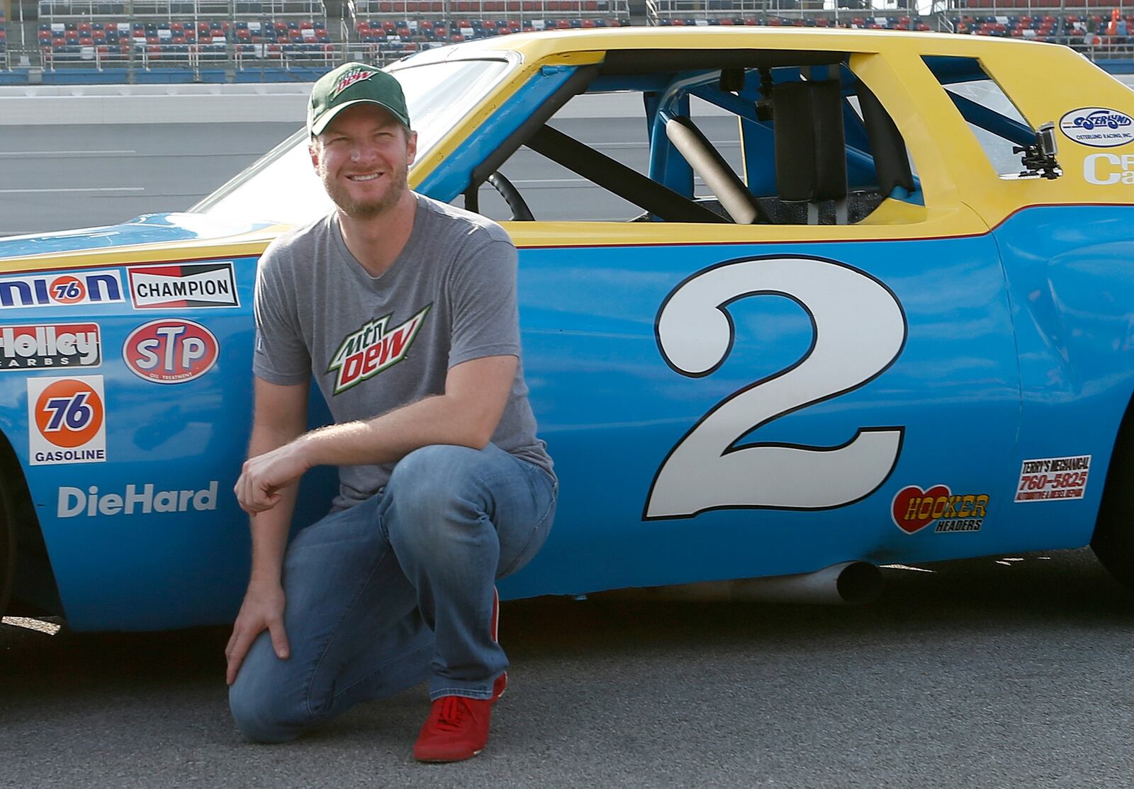 Dale Earnhardt Jr. poses with Talladega's parting gift to him: His father's car of 37 years ago. (Brian Lawdermilk/Getty Images)